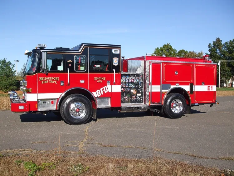 Driver-side profile view showing pump controls and rear body compartments