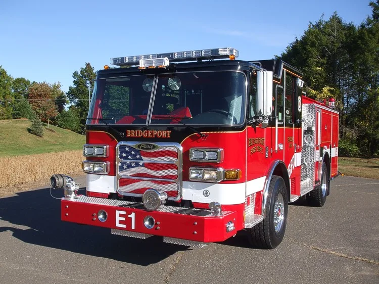 Front-left close view showing grille, bumper, and warning lights