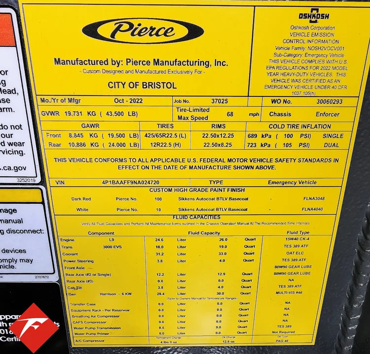 Cab door-jamb close-up showing yellow specification label plate