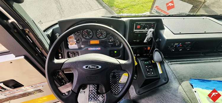 Driver cockpit view showing steering wheel, dashboard, and center controls