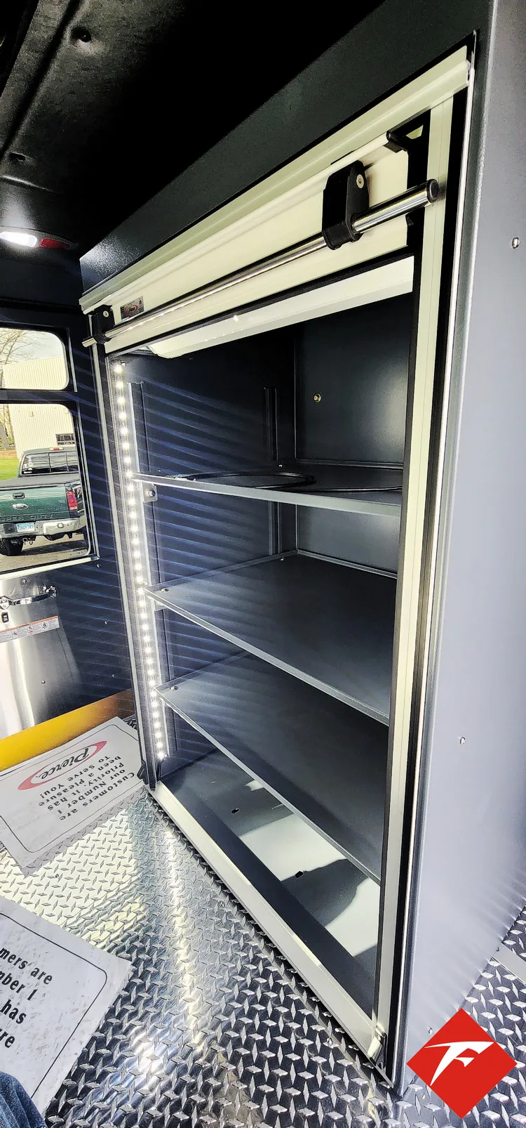 Open side compartment showing empty shelf bay and pull-out tray