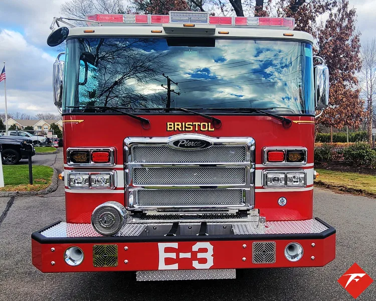 Head-on front view showing grille, bumper, and warning lights