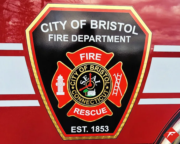 Cab door close-up showing city fire rescue crest on red paint