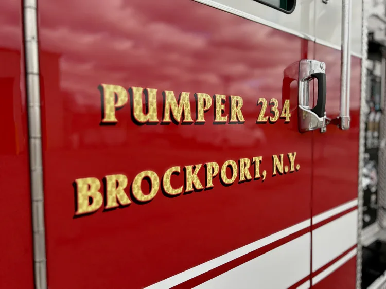 Cab door close-up showing pumper unit lettering and door handle