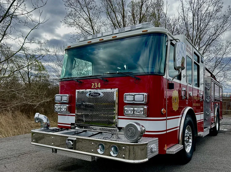 Pumper front view showing grille, headlights, and bumper-mounted siren