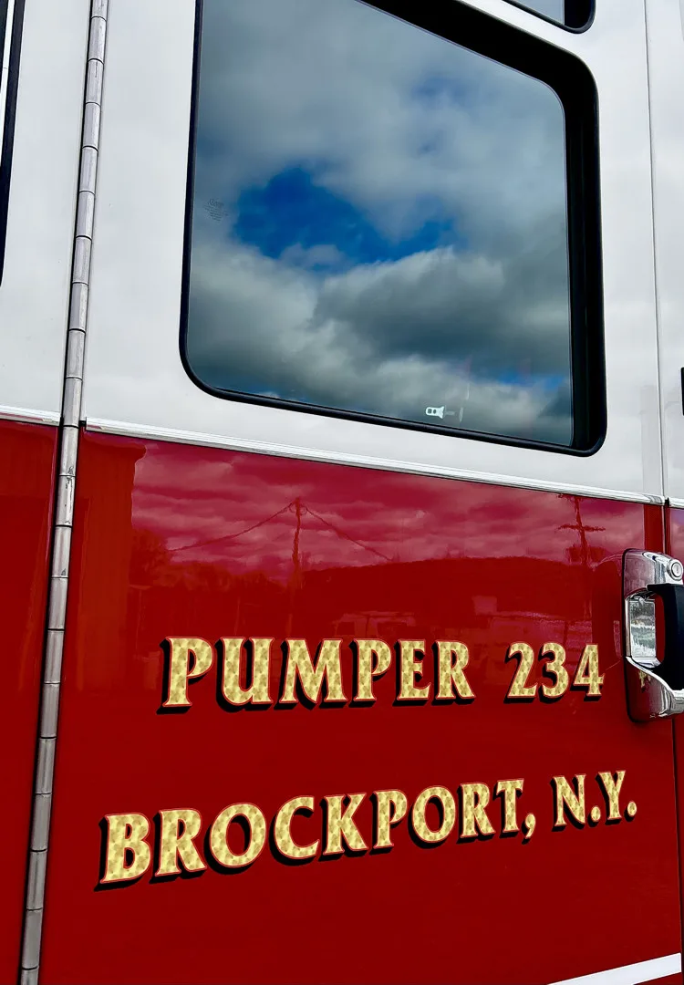 Cab-side close-up showing pumper lettering and side window