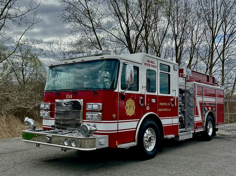 Pumper front-right exterior view parked roadside with side pump panel visible