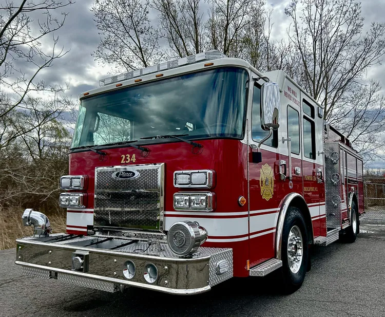 Pumper front view showing grille, warning lights, and bumper-mounted siren