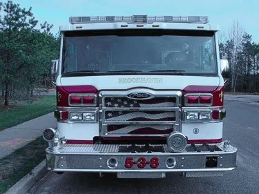 Front exterior view showing grille, bumper, and warning lights