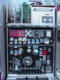 Pump panel close-up showing gauges, valves, and control levers