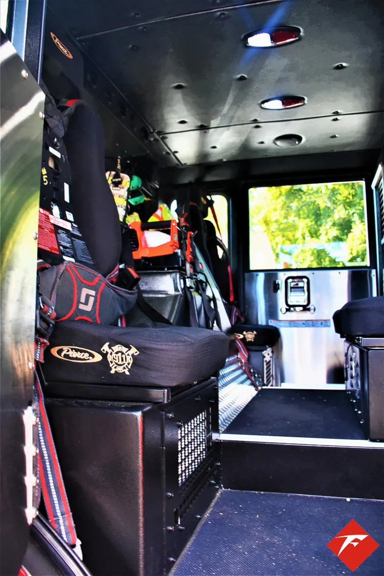 Cab interior side view showing center aisle and rear seat area