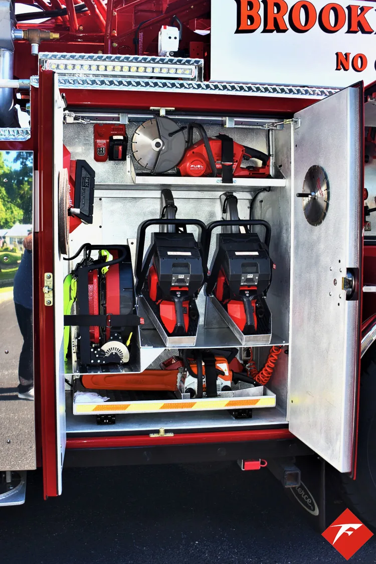 Open side compartment showing rescue tools mounted in vertical rack
