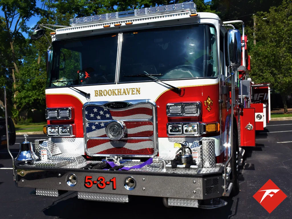 Head-on front view showing grille, bumper, and warning lights