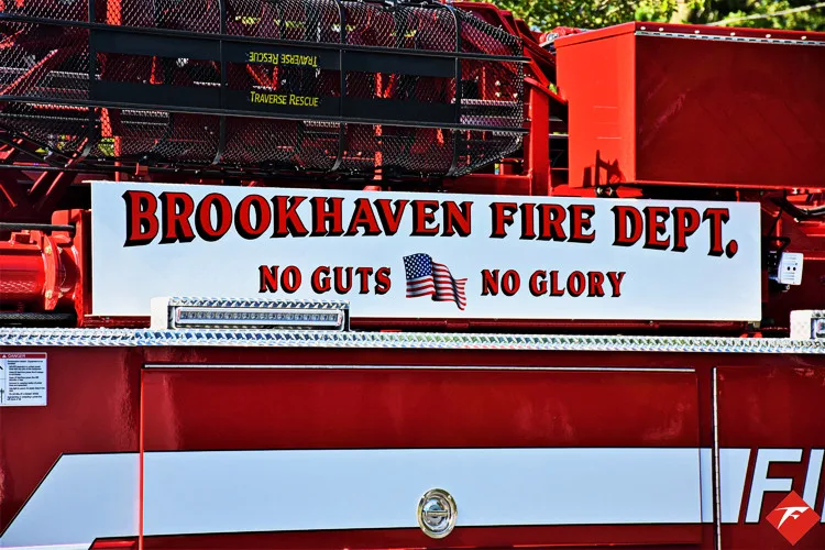 Body side lettering close-up on red panel above compartments
