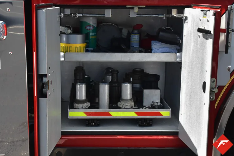 Open side compartment showing utility containers and shelf storage