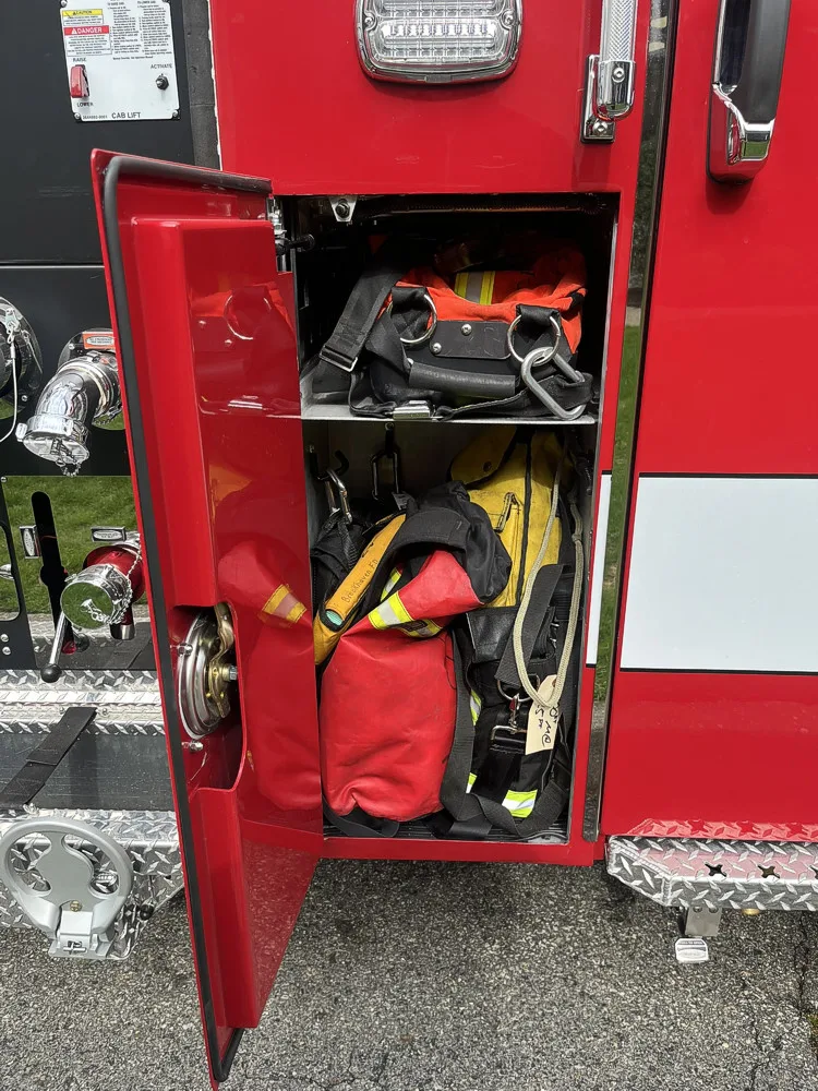 Small side compartment near pump panel with bags and turnout gear storage