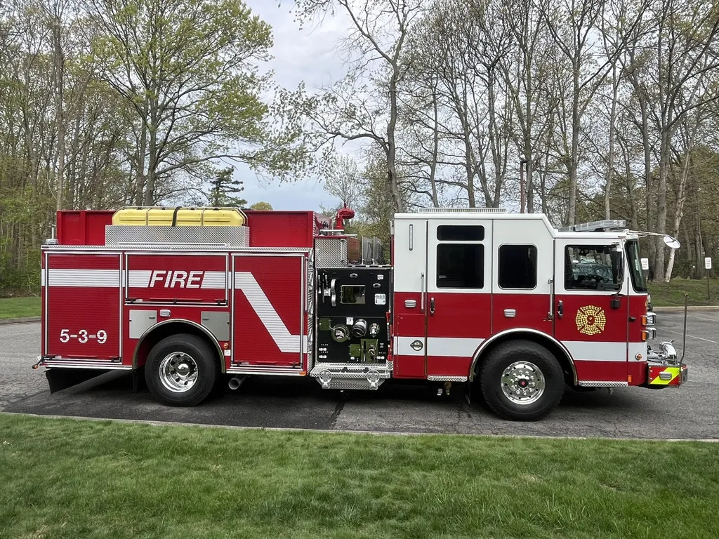 Pierce Saber pumper, driver-side profile with open compartments, pump panel, and tool tray
