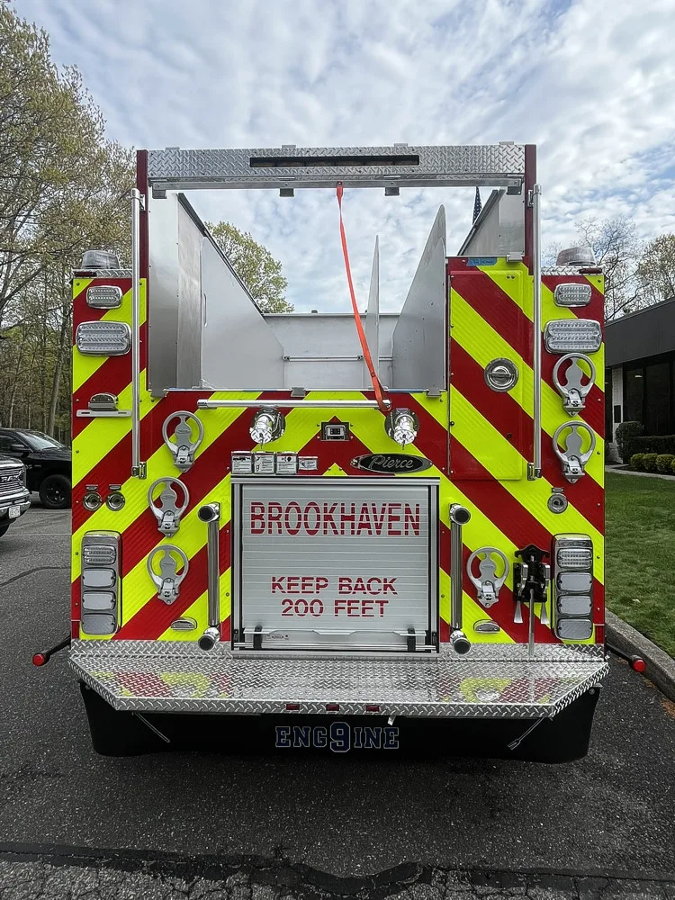 Rear view showing chevron striping, hosebed opening, and rear hose connections