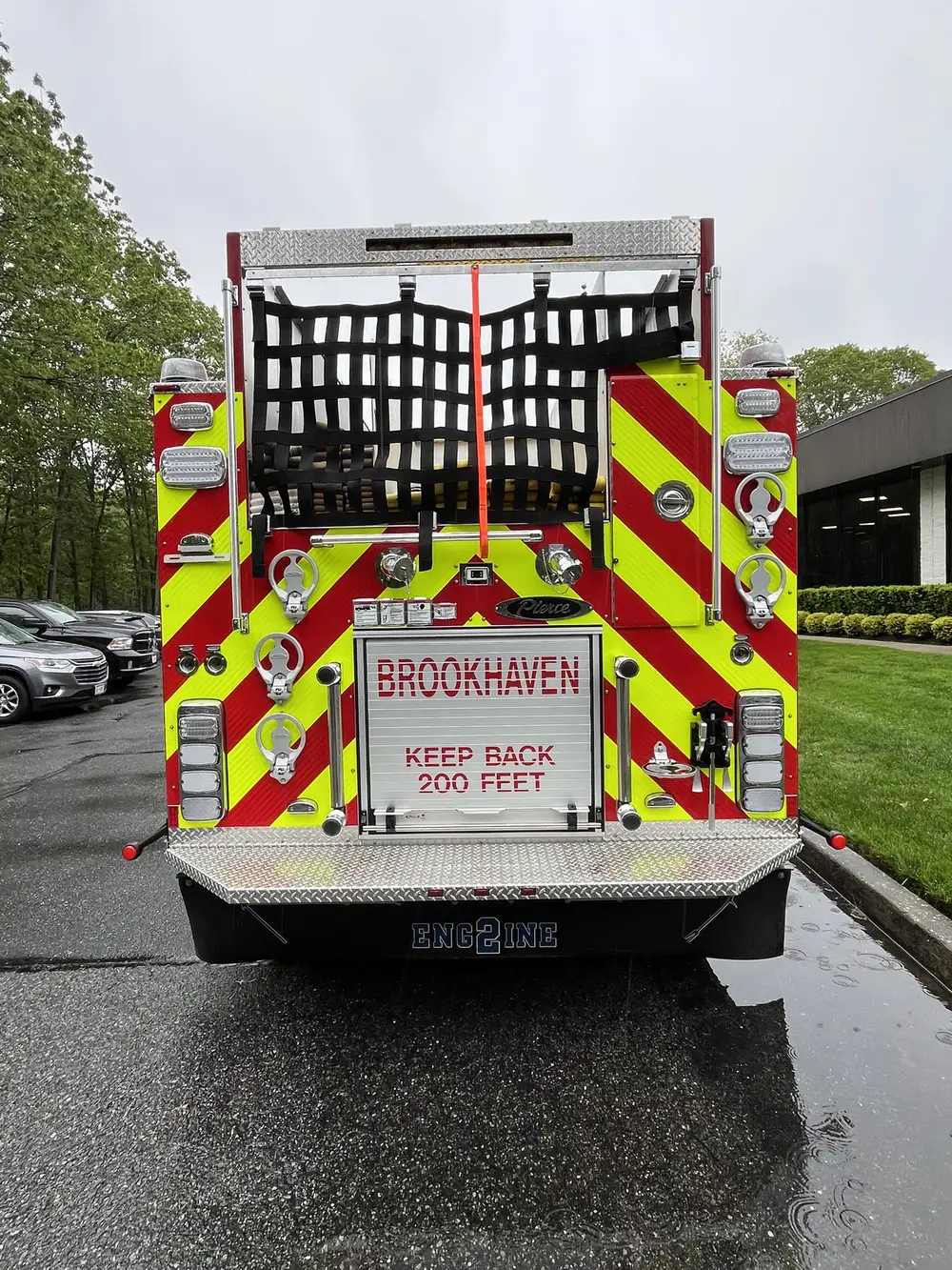 Rear view showing chevron striping, hosebed netting, and lower rear door