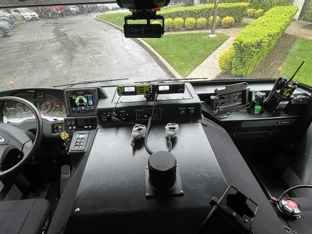 Cab cockpit view showing center console, radios, and dashboard controls