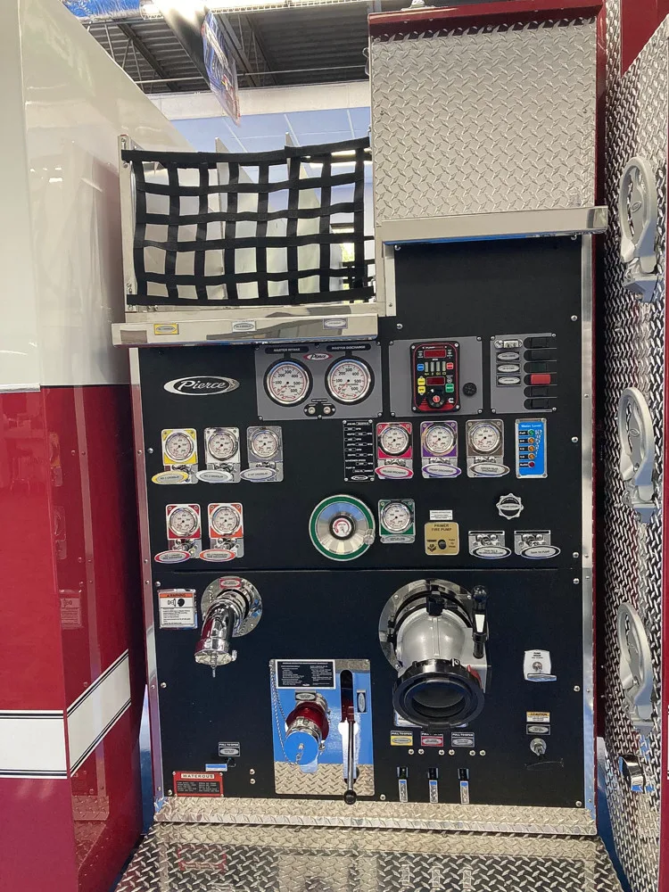 Pump panel close-up showing gauges, valves, and intake controls