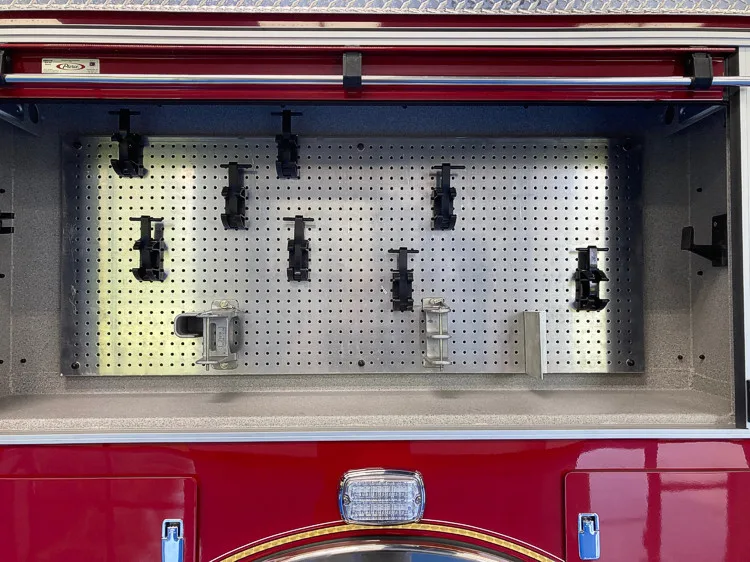 Open side compartment showing mounted hand tools and pegboard panel