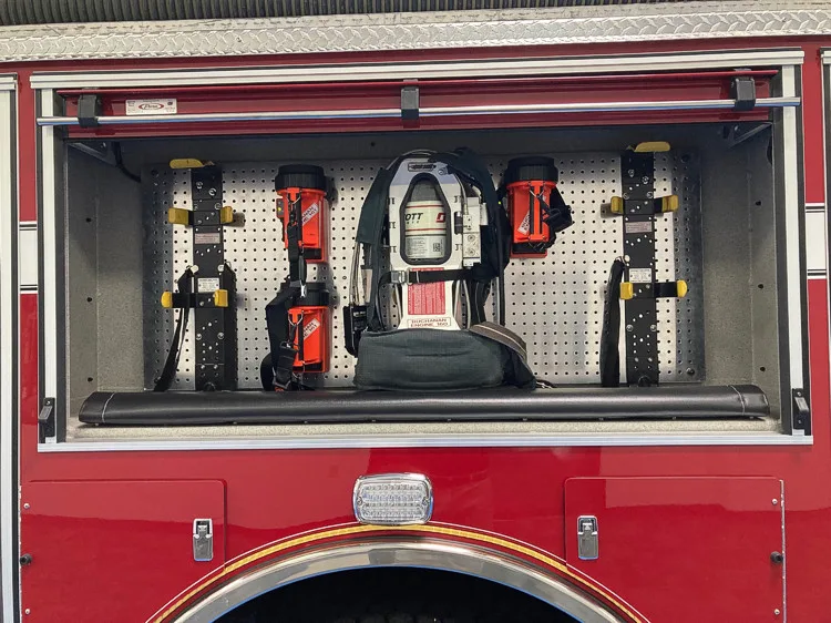 Open side compartment showing cordless tools and rack storage