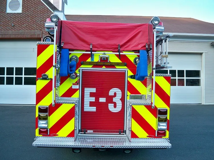 Rear view showing chevron striping, rear door panel, and warning lights
