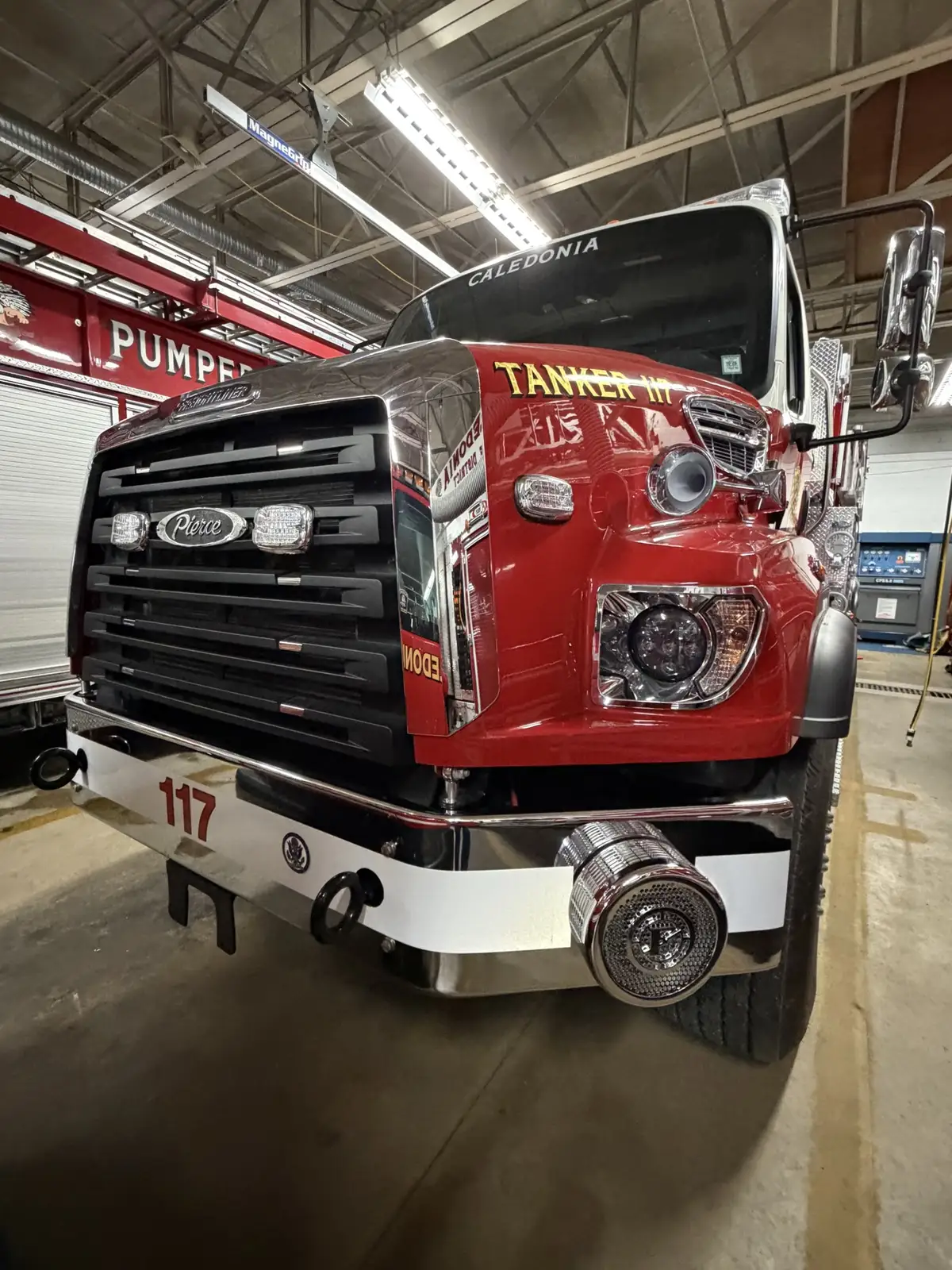 Front view showing grille, bumper, warning lights, and hood badging