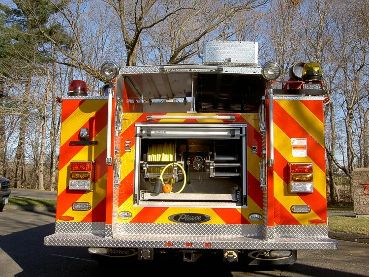 Rear view with open upper compartment showing hose reel and rear discharge controls