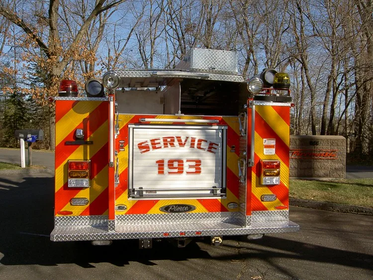Rear view showing red-yellow chevrons and rear roll-up door marked Service 193