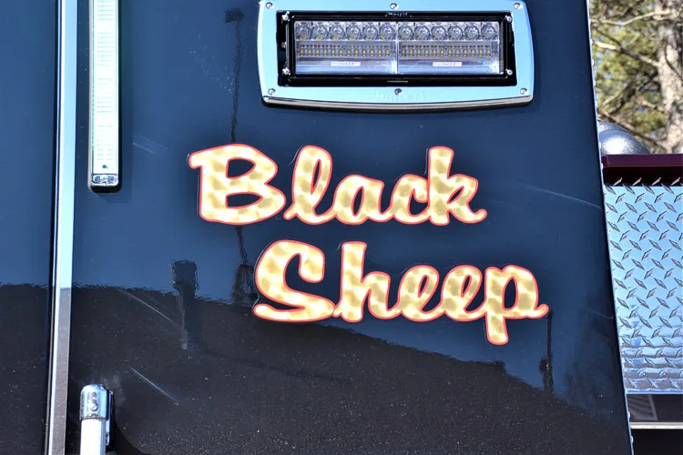 Interior detail close-up showing embroidered panel lettering on a dark surface