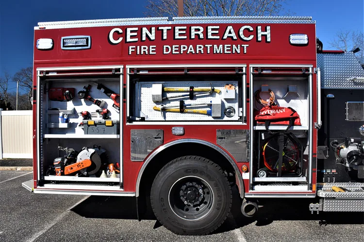 Officer-side compartment view with door open showing hand tools and equipment shelves