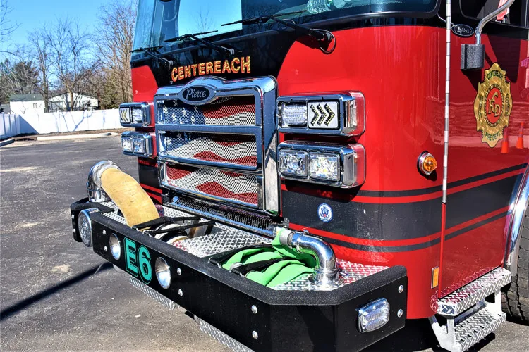Front-left close-up showing bumper, intake fitting, and front warning lights