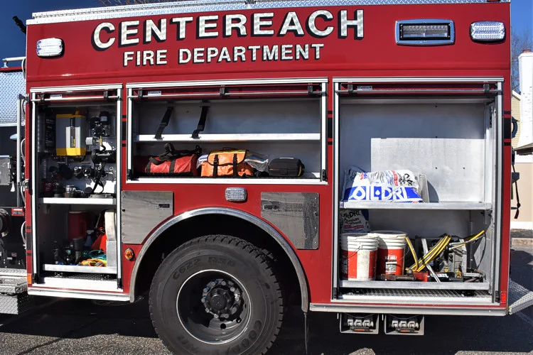 Officer-side body close-up with open compartment showing tools and storage bins