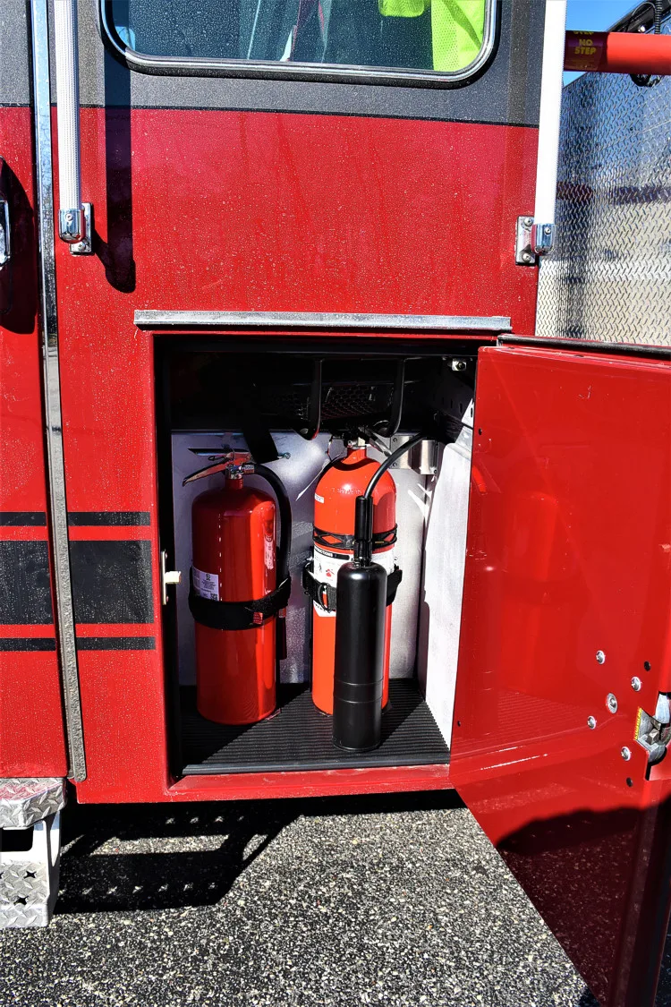Open lower side compartment showing mounted extinguishers and storage space