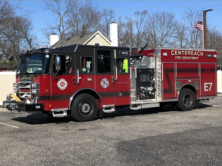 Driver-side profile view showing open side compartments, pump panel area, and rear wheel