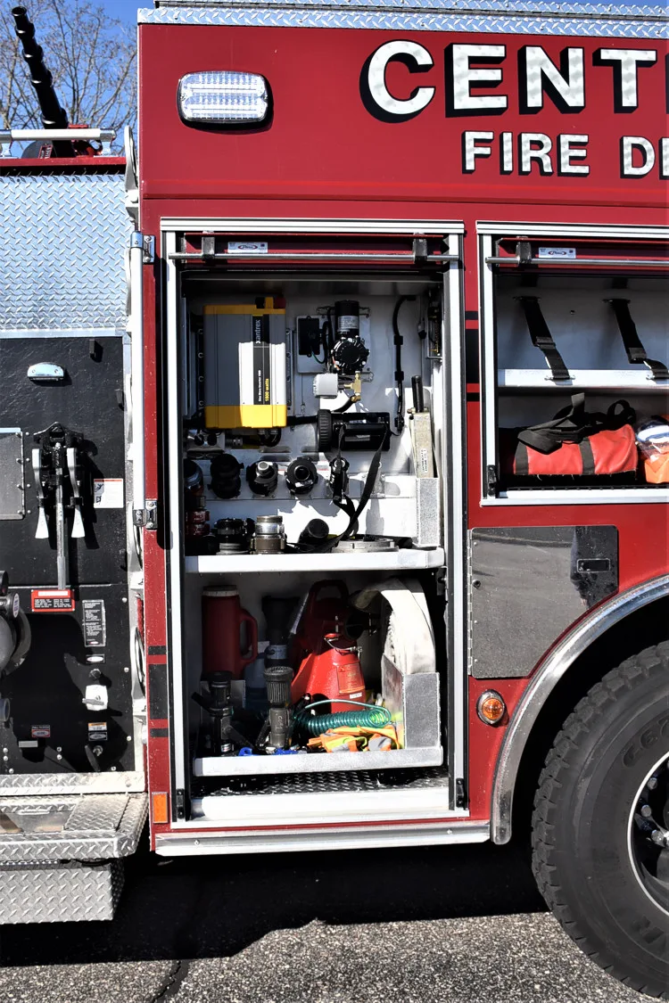 Open side compartment showing mounted tools, fittings, and shelf storage