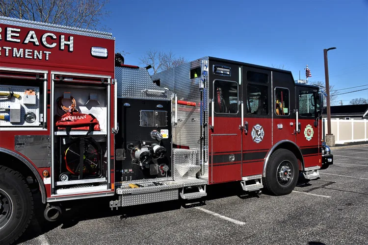Officer-side profile view with open body compartments and tool storage shelves