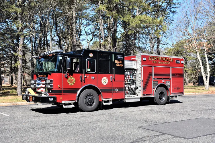 Driver-side full profile view showing pumper body, side compartments, and wheelbase
