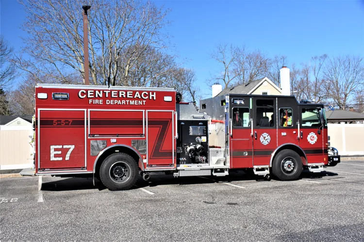 Driver-side profile view with open mid-body compartments and pump panel section