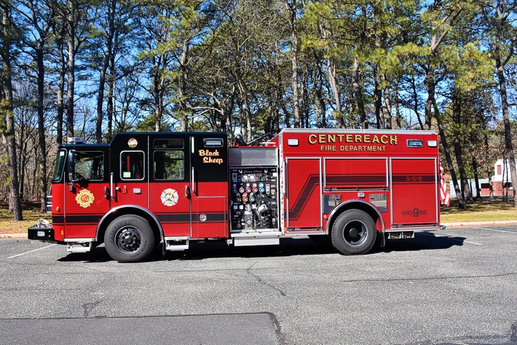 Driver-side profile view showing pumper body, side compartments, and rear section
