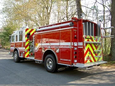 Rear-right three-quarter view showing side hosebed rails and rear wheel area