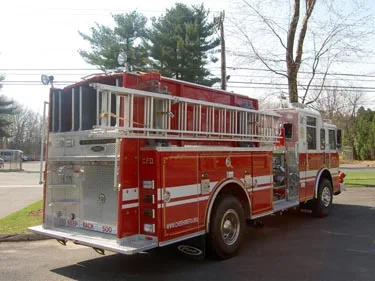 Rear-right exterior view showing side hosebed rails and rear wheel area