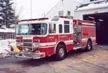 Pumper front-left exterior view showing enclosed cab and side compartments