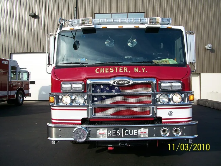 Head-on front view showing grille, windshield, warning lights, and bumper-mounted intake ports.