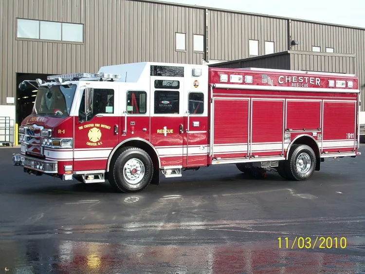 Driver-side full profile showing long compartment doors, cab doors, and full wheelbase.