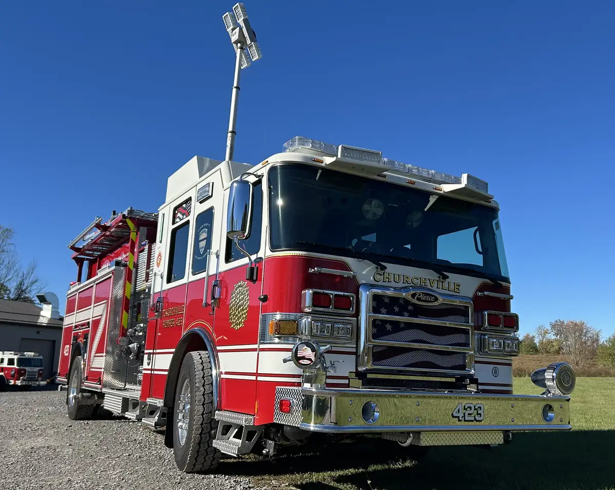 Pierce pumper low front-right angle showing chrome bumper and cab