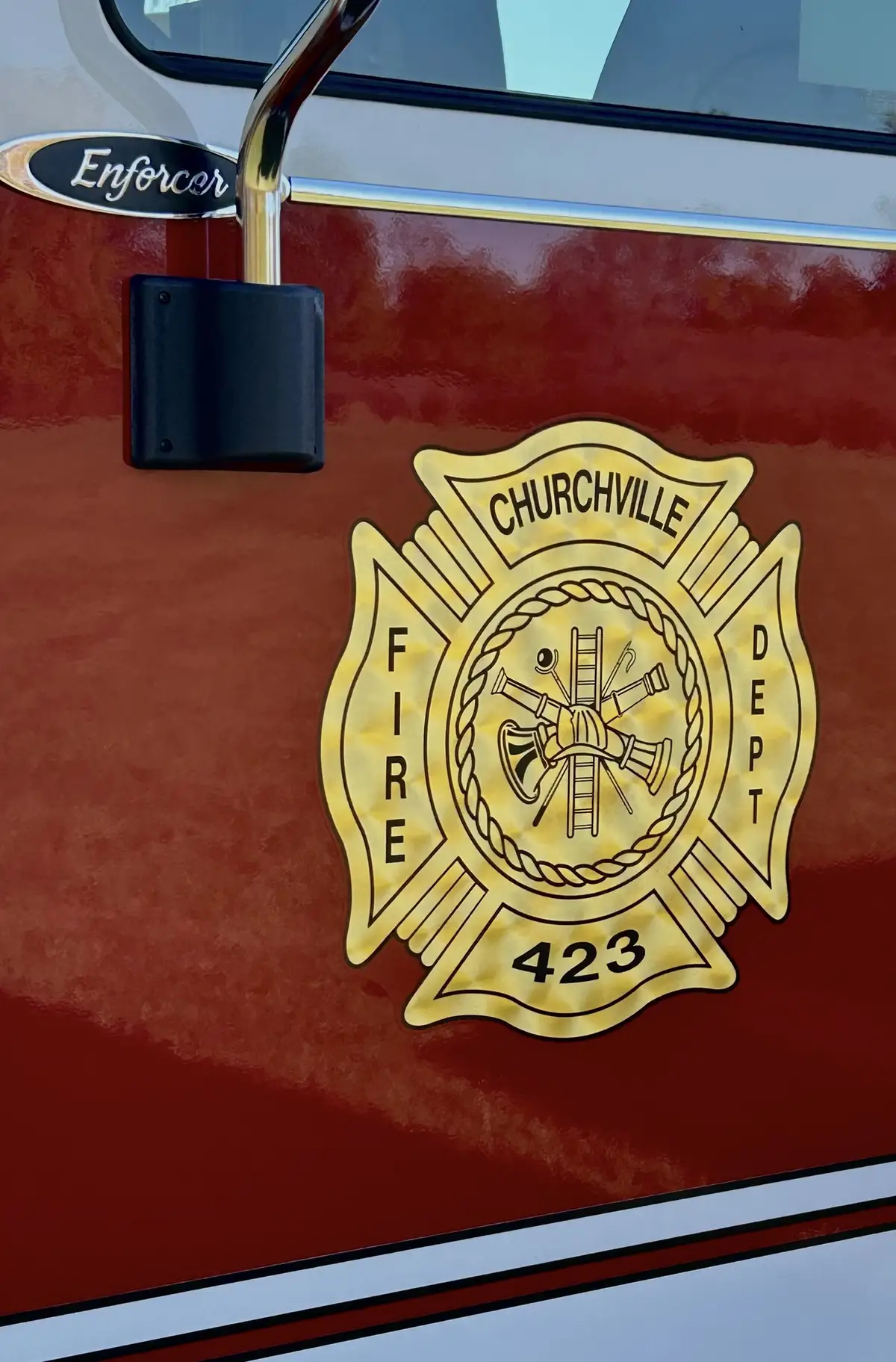 Cab door crest close-up on red body panel