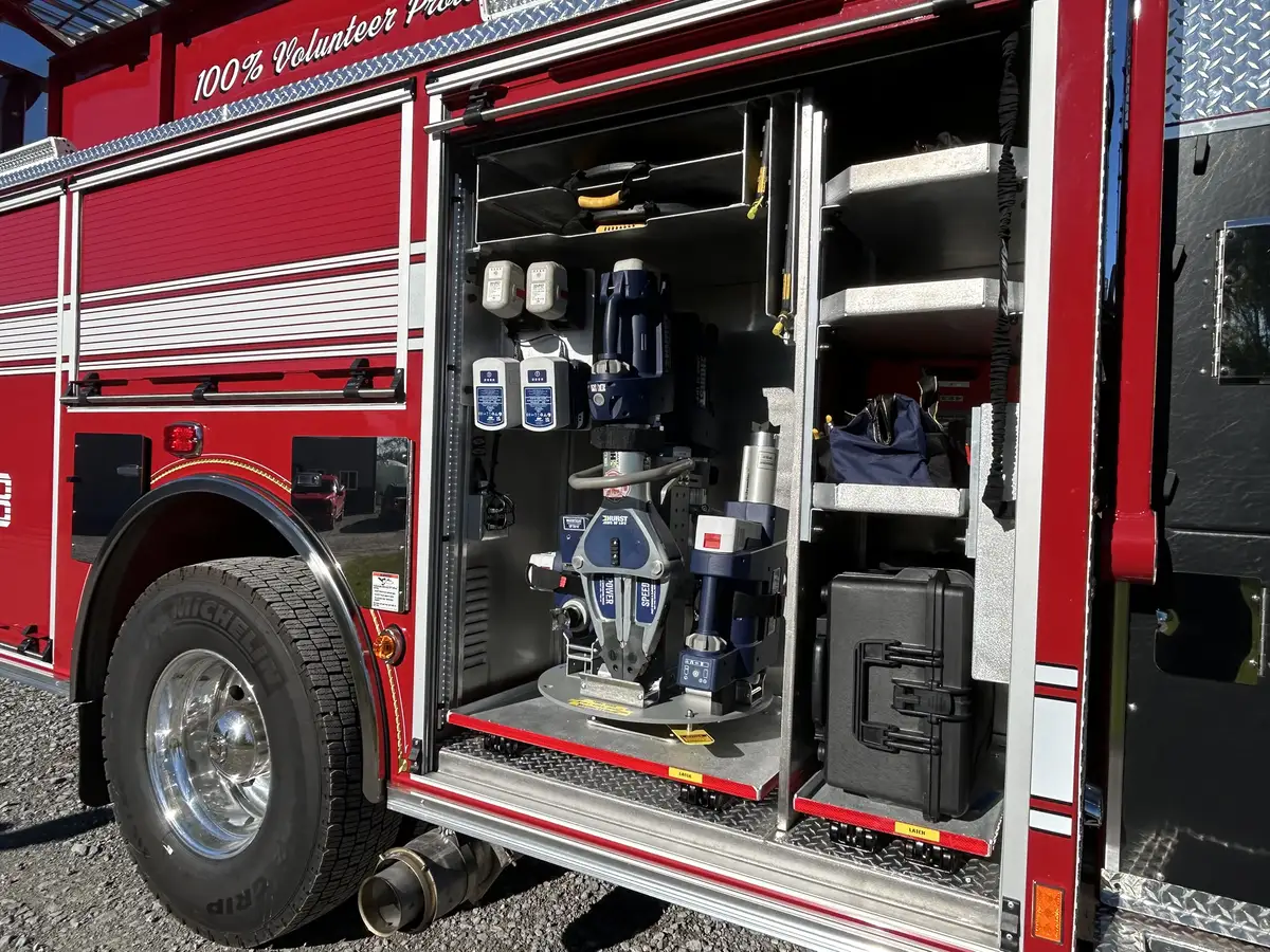 Open side compartment wide view with hydraulic rescue tool and hard case